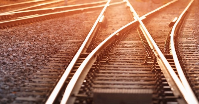 Railway track in the evening in sunset. Panoramic view on the railroad switch.